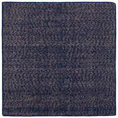 Detail of the Penta Rug in Tempestl, a subtle striated pattern in indigo blue and taupe. 