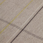 Detail of the Jasper Waffle Rug in Peridot, a large scale plaid pattern of ecru, yellow, grey and off white. 