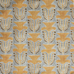 Fabric swatch with a stamped painted floral motif in yellow and brown on a grey background