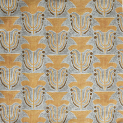 Fabric swatch with a stamped painted floral motif in yellow and brown on a grey background
