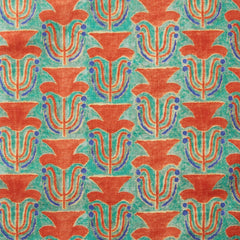 Fabric swatch with a stamped painted floral motif in vibrant red and cobalt on an emerald green background