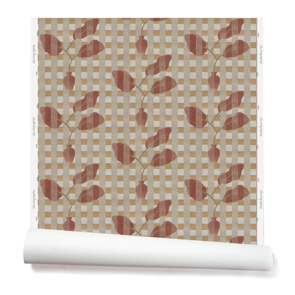 Wallpaper roll with a complex two tone warm pink and soft red floral motif overlayed a white and tan plaid pattern. 