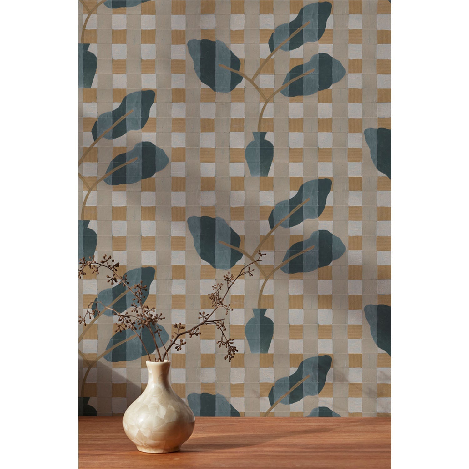 A small dried floral branch in an off white vase against a wallpaper with a complex chambray and petrol blue floral motif overlayed a white and tan plaid pattern, hover