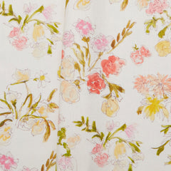 Folded linen swatch with a pattern of large-scale line-drawn flowers in gray ink with red, pink and yellow watercolors, on a beige background.