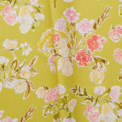Folded linen swatch with a pattern of large-scale line-drawn flowers in gray ink with red, pink and yellow watercolors, on a light green background.