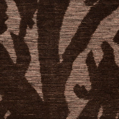 Detail of Capri Rug with a large abstract design shades of brown over varied stried lighter color background