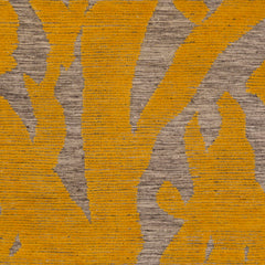 Detail of Capri Rug with a large abstract design shades of yellow over varied stried lighter neutral color background