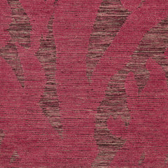 Detail of Capri Rug with a large abstract design shades of pink over varied stried lighter color background