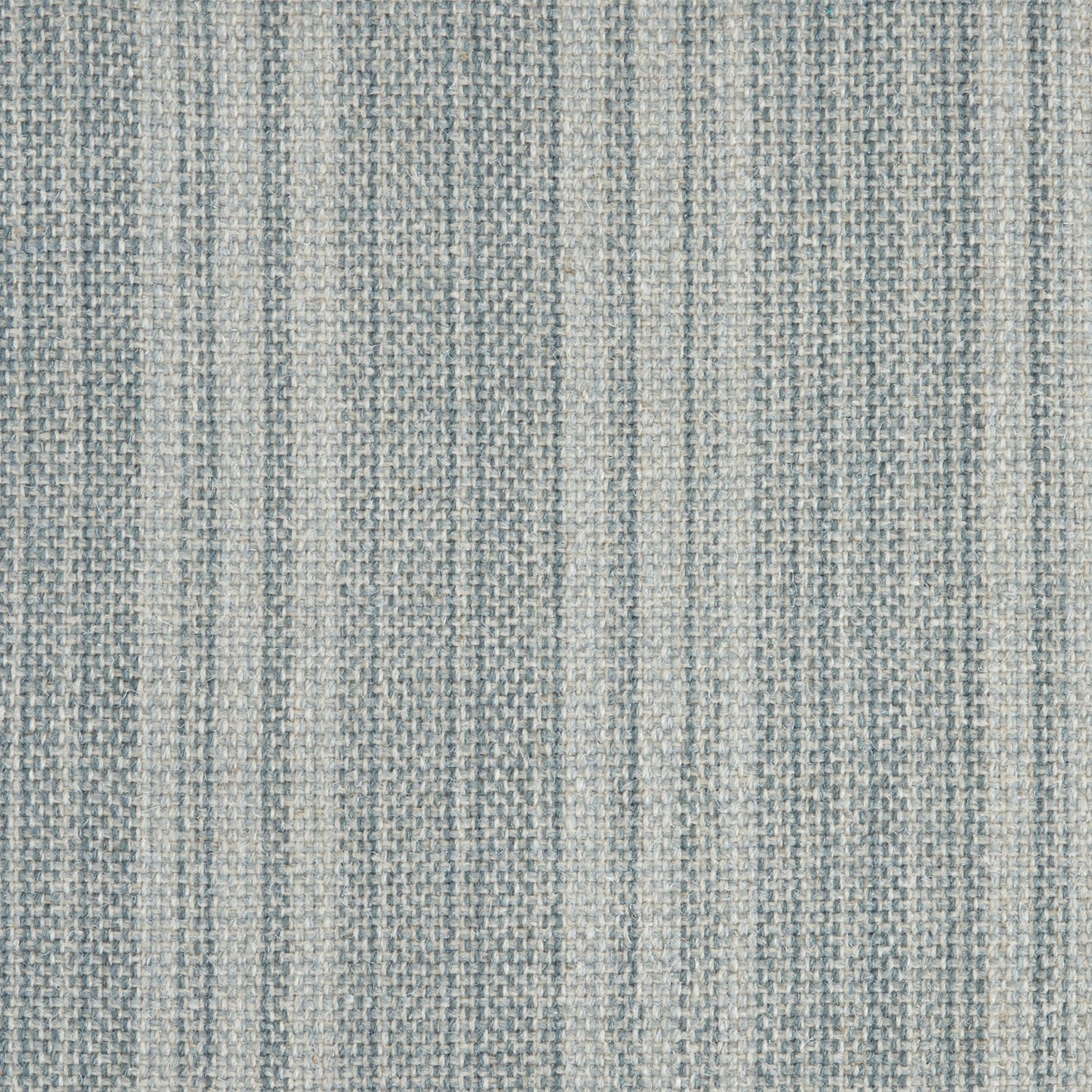 Wool broadloom carpet swatch in a light blue colorway mottled with gray and blue fibers.