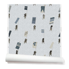 A roll of wallpaper with a pattern of hand-drawn Japanese soldiers carrying various geometric flags, on a light gray background.