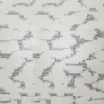 Wool broadloom carpet swatch in a woven cloud pattern in cream with light gray accents.