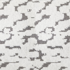 Wool broadloom carpet swatch in a woven cloud pattern in cream with dark gray accents.