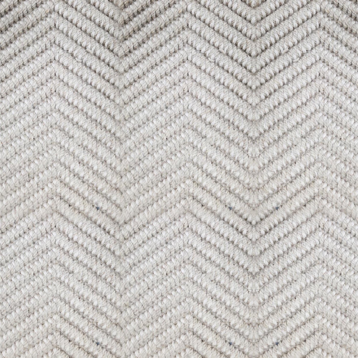 Wool broadloom carpet swatch in a dimensional chevron weave in a light silver colorway.