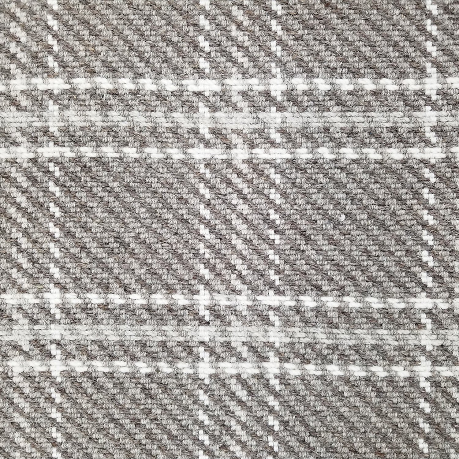 Wool broadloom carpet swatch in houndstooth plaid in shades of gray and cream.