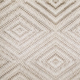 Wool broadloom carpet swatch woven in a dimensional diamond print in cream.