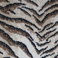 Wool broadloom carpet swatch in a tiger print in black and bronze on a mottled cream field.