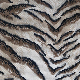 Wool broadloom carpet swatch in a tiger print in black and brown on a mottled cream field.