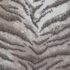 Wool broadloom carpet swatch in a tiger print in tan and brown on a mottled cream field.