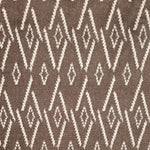 Woven broadloom carpet swatch in a repeating irregular diamond pattern in white on a dark brown field.