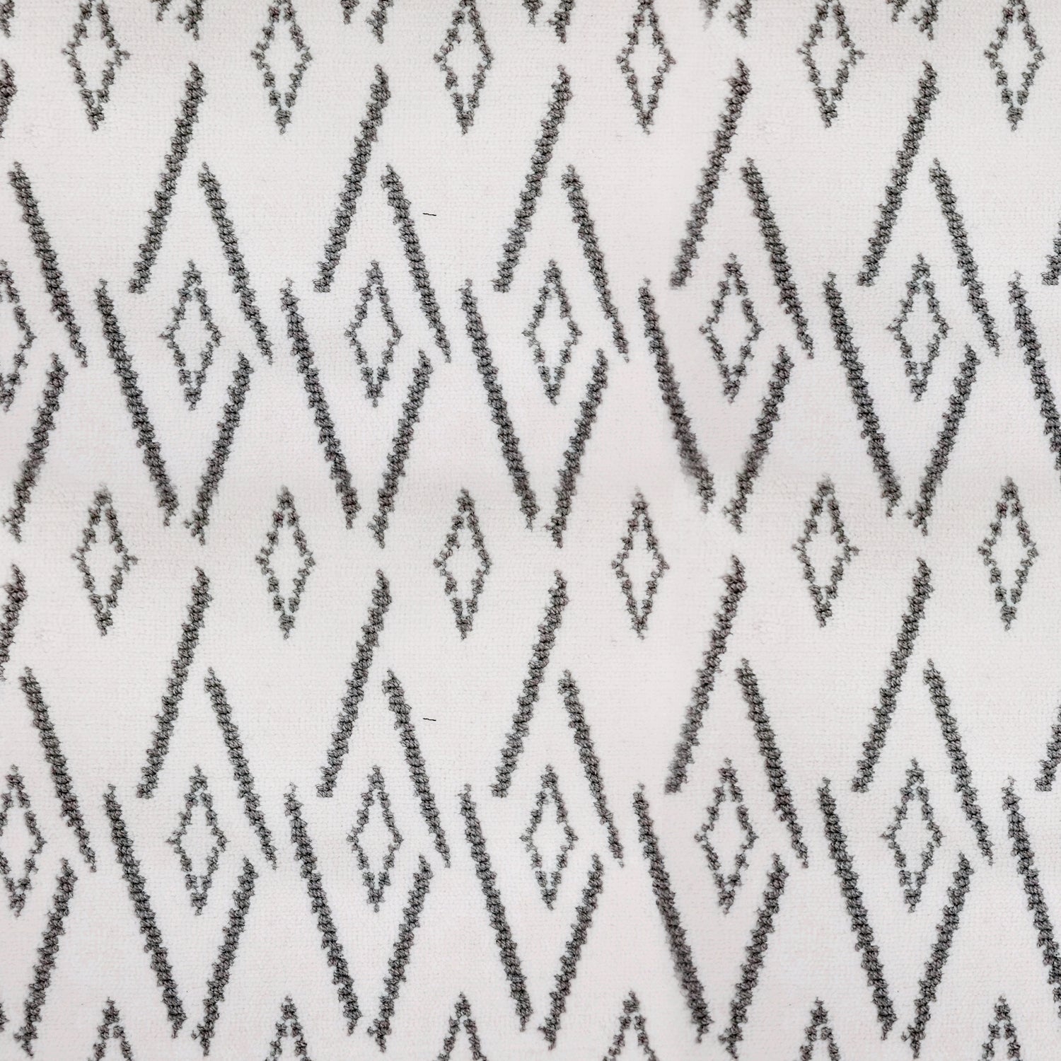 Woven broadloom carpet swatch in a repeating irregular diamond pattern in charcoal on a cream field.