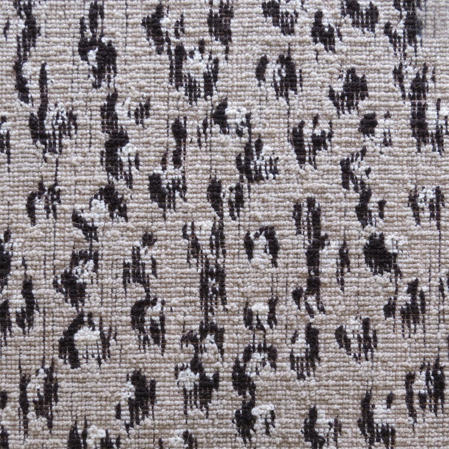 Wool broadloom carpet swatch in a painterly floral pattern in black and cream on a brown field.