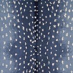 Wool-nylon broadloom carpet swatch in an antelope print in cream on an ombré navy field.