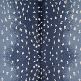 Wool-nylon broadloom carpet swatch in an antelope print in cream on an ombré navy field.
