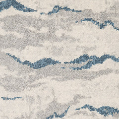 Wool-nylon broadloom carpet swatch in a painterly cloud pattern in shades of cream, gray and navy.