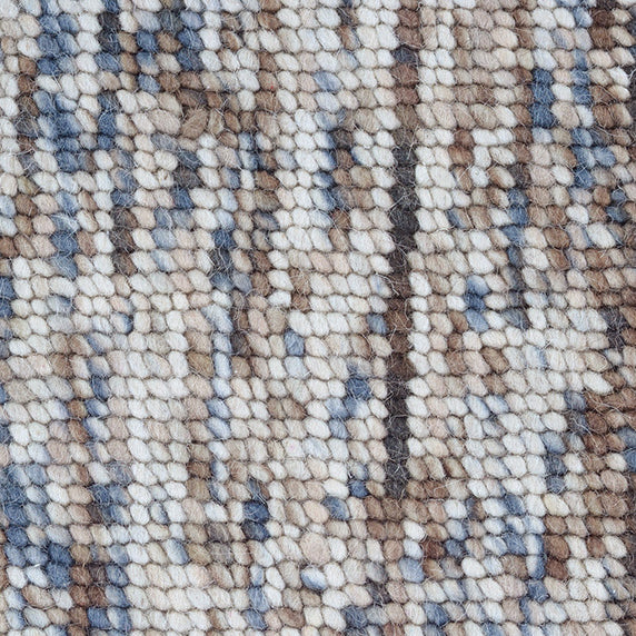 High-pile wool broadloom carpet swatch in a mottled cream, brown and blue colorway.