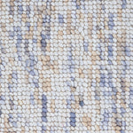 High-pile wool broadloom carpet swatch in a mottled white, brown and blue colorway.