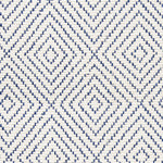 Wool broadloom carpet swatch in a graduated diamond print in navy on a cream field.