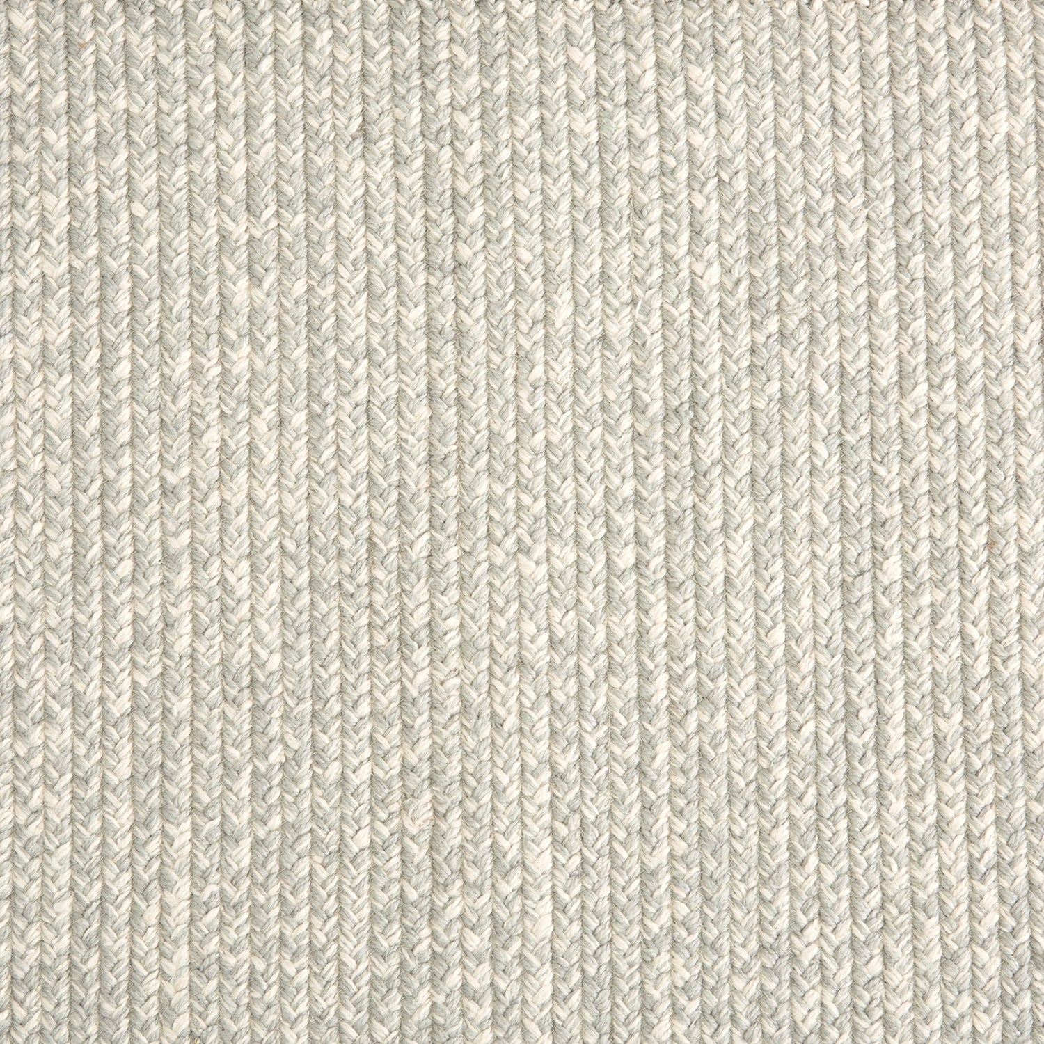 Outdoor broadloom carpet swatch in a chunky ribbed weave in mottled cream and gray.