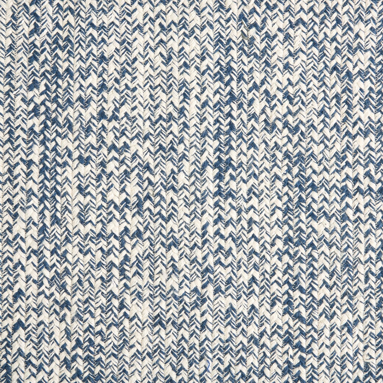 Outdoor broadloom carpet swatch in a chunky ribbed weave in mottled cream and navy.