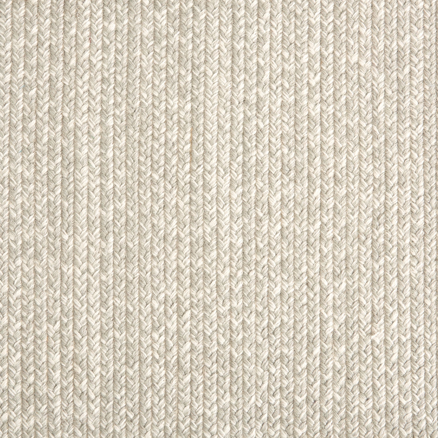 Outdoor broadloom carpet swatch in a chunky ribbed weave in mottled cream and silver.