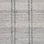 Wool-blend broadloom carpet swatch in a plaid tweed weave in cream and silver.
