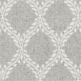 Wool broadloom carpet swatch in a leafy lattice print in white on a light gray field.