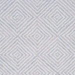 Wool broadloom carpet swatch in a dense repeating diamond print in shades of mauve and cream.