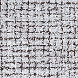 Wool broadloom carpet swatch in a high-pile weave in mottled white, gray and dark brown.