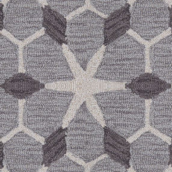 Wool broadloom carpet swatch in a geometric lattice pattern in cream and charcoal on a gray field.