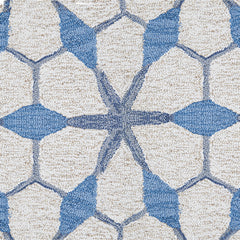 Wool broadloom carpet swatch in a geometric lattice pattern in shades of blue on a cream field.
