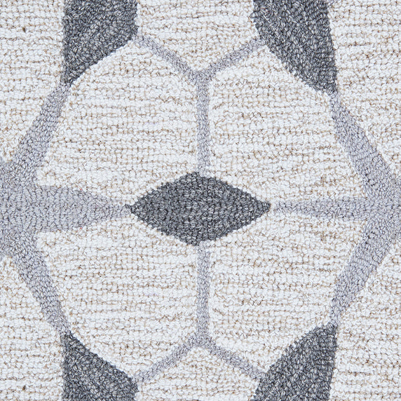 Detail of a wool broadloom carpet swatch in a geometric lattice pattern in shades of grey on a cream field.