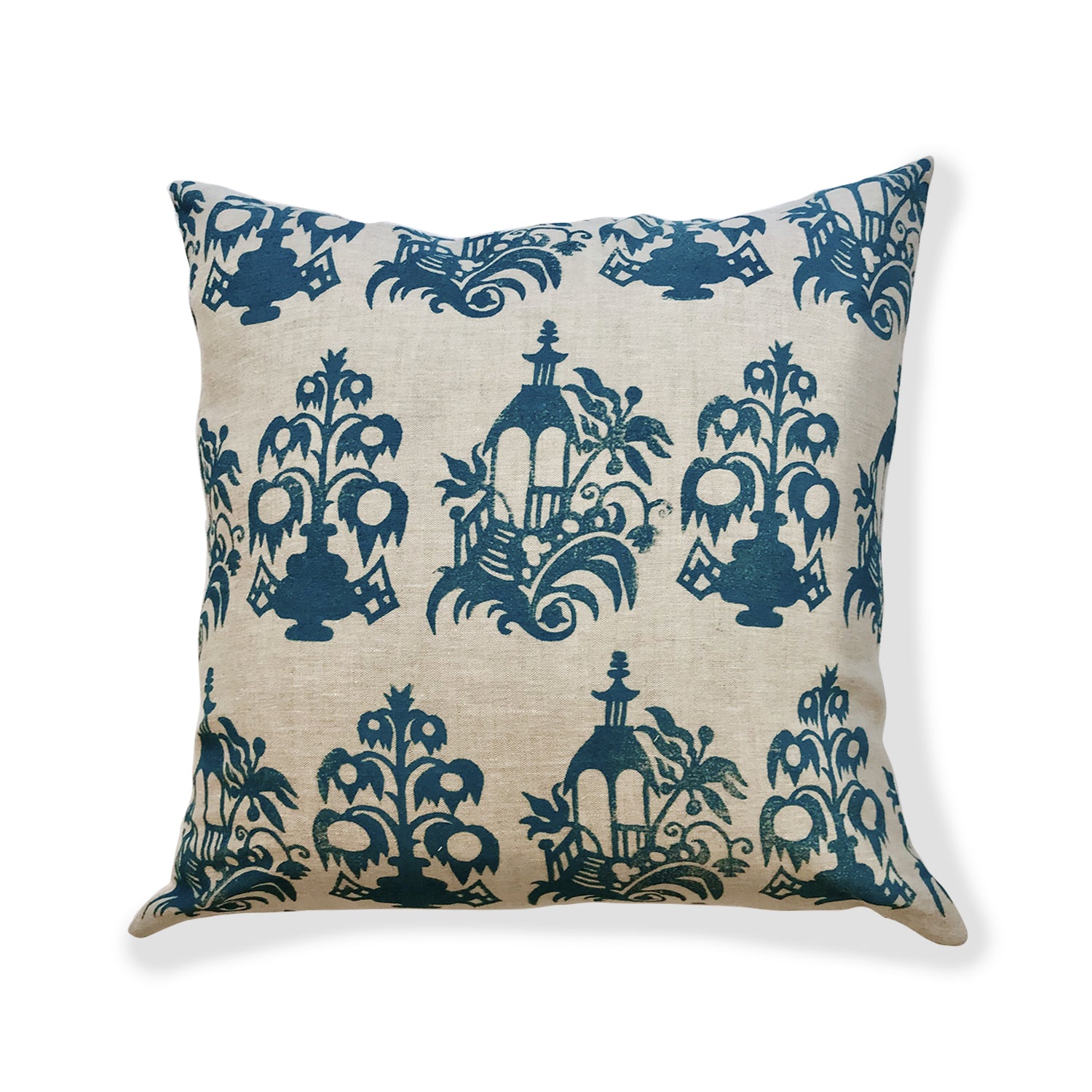 Square throw pillow with a repeating block print of florals and gazebos in navy on a tan field.