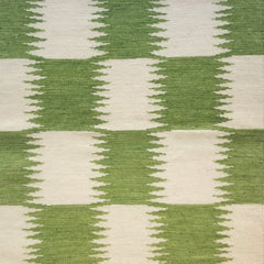 Woven rug swatch in an Ikat grid pattern in white and green.