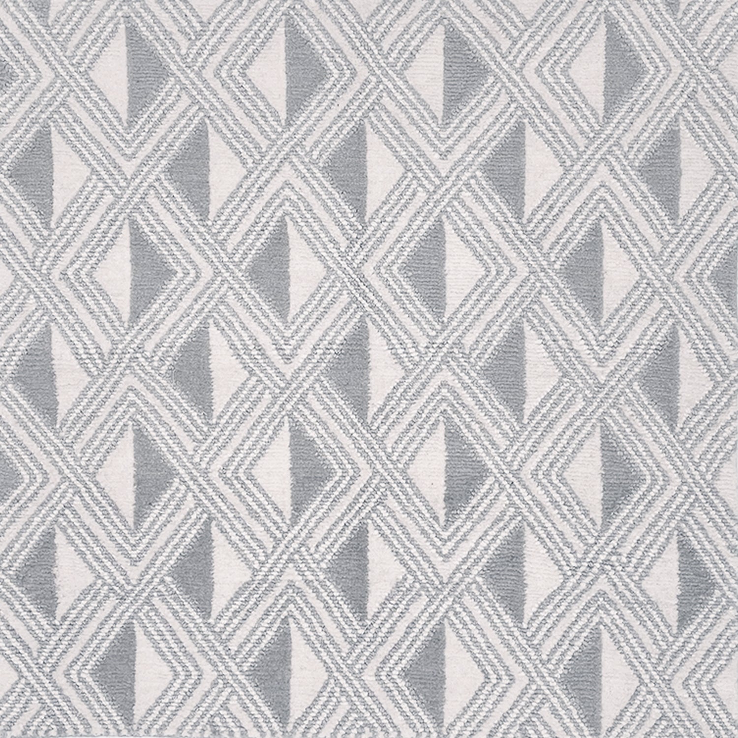 Detail of a woven high-pile rug in an interlocking diamond pattern in gray and white.