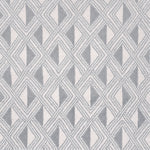 Detail of a woven high-pile rug in an interlocking diamond pattern in gray and white.