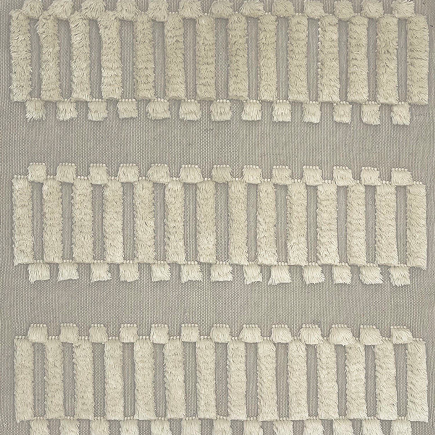 Woven rug swatch with a repeating pattern of high-pile fringed stripes in cream on a gray field.