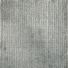 Nylon broadloom carpet swatch in a ribbed weave in grey.