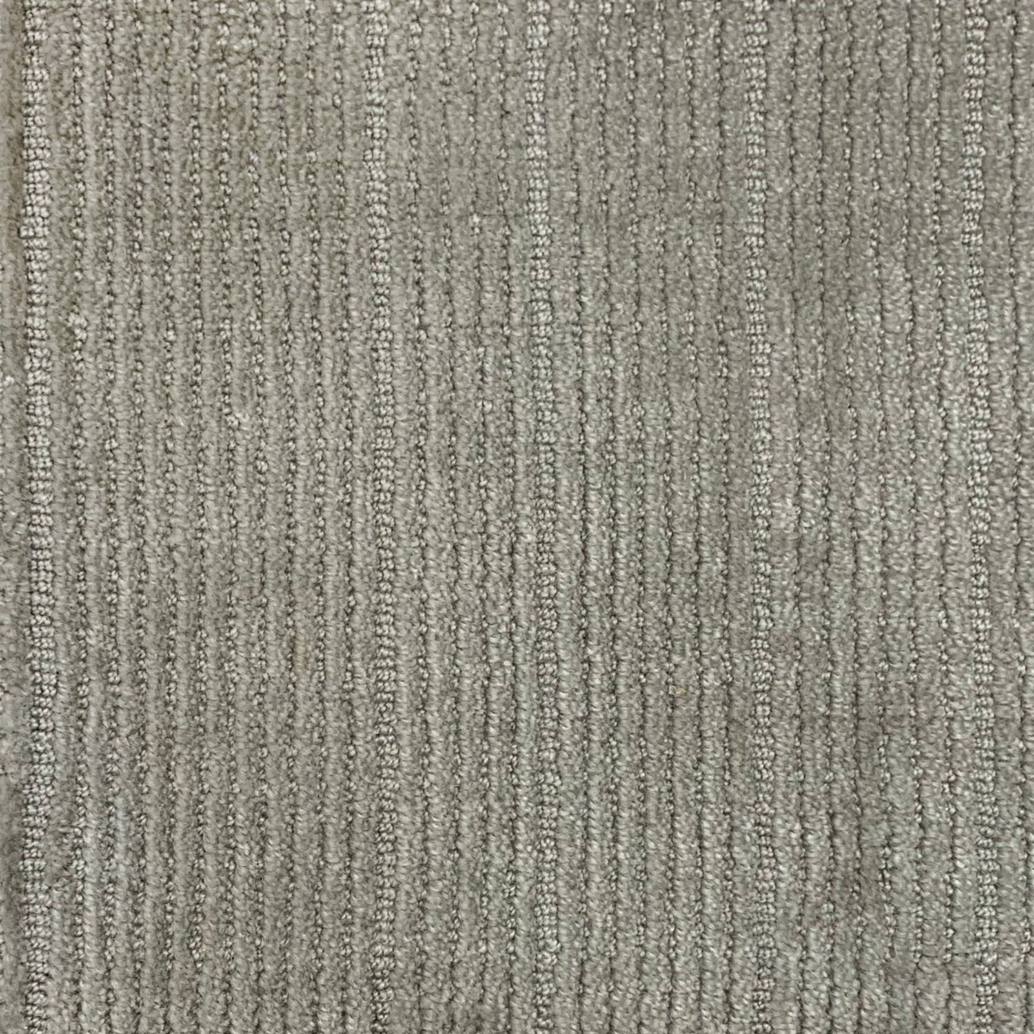 Nylon broadloom carpet swatch in a ribbed weave in silver.