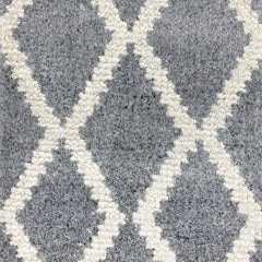 Wool-blend broadloom carpet swatch in a cream and gray diamond lattice print.