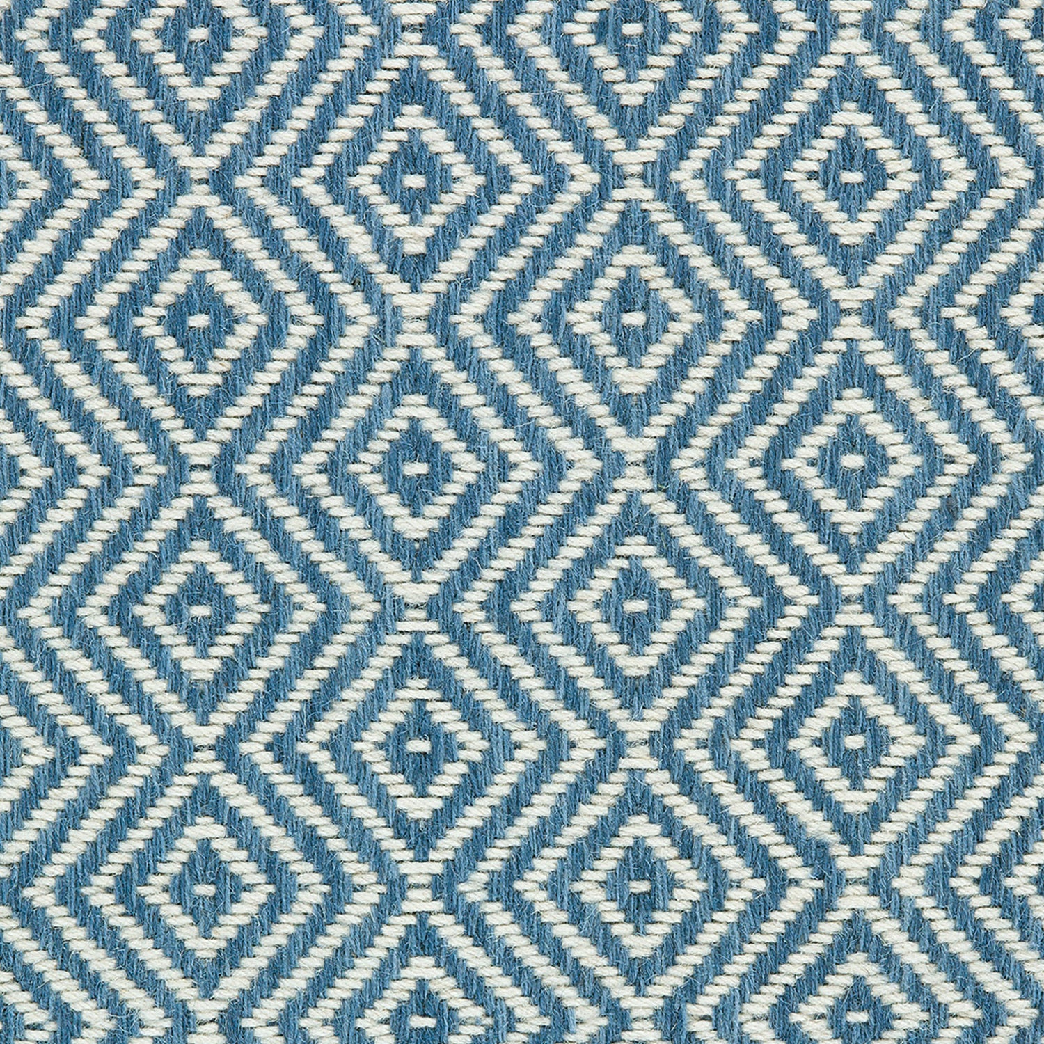 Wool broadloom carpet swatch in a diamond lattice weave in blue and cream.